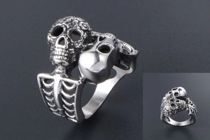 Detailed macro view of the gothic skull and ribcage structure on a silver metal ring