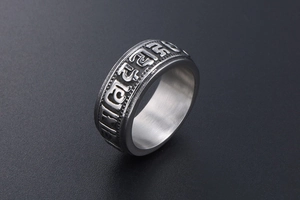 Macro detail of titanium steel ring with embossed Mantra and vintage religious texture