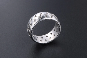 Detailed close-up of a silver cuban chain link ring with industrial hollowed-out design