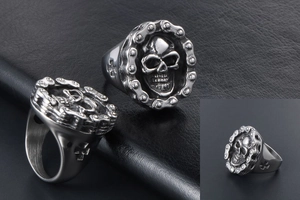 Detailed macro of vintage skull ring featuring industrial chain links and cross engraving