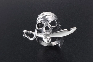 Détail macro d'une bague tête de mort pirate avec sabre en acier inoxydable poli
