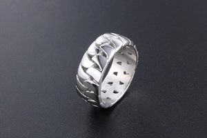 Macro shot of silver titanium ring featuring an edgy geometric shark tooth embossed design