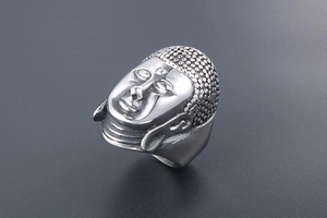 Macro shot of retro stainless steel ring with 3D Buddha head sculpture in silver finish