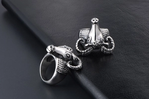 Detailed close-up of retro stainless steel antelope head ring with rock punk textures
