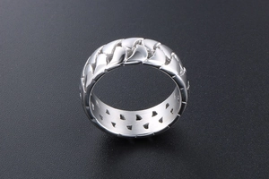 Close-up of a silver polished stainless steel ring with creative Cuban chain texture