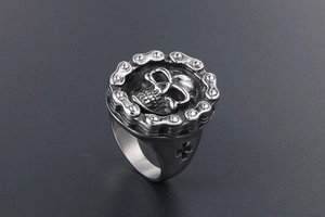 Detail of vintage skull ring with chain border and hollow cross side design