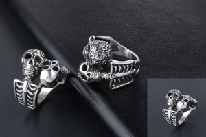 Macro shot of silver gothic skull ring with rib textures and vintage metal finish