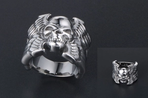 Détail d'une bague gothique tête de mort avec ailes en acier titane poli brillant