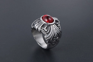 Gothic titanium steel ring featuring a large oval red gemstone with ornate relief carvings