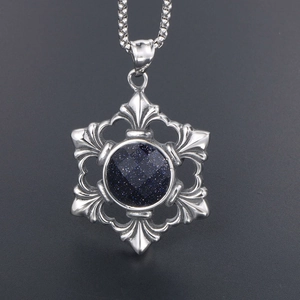 Vintage silver hollow snowflake necklace with blue sandstone pendant on dark background