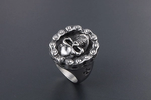 Detail of vintage skull ring with chain link border and engraved cross on the side
