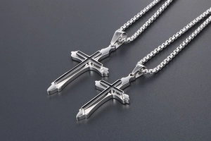 Detailed macro view of silver polished titanium steel double layer cross pendant