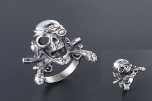 Macro detail of men's steel pirate skull ring featuring crossed muskets and eye patch