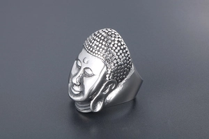 Detailed view of Buddha head carving on a matte finish vintage titanium steel ring