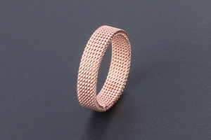 Detailed view of rose gold titanium steel mesh ring with Milanaise woven texture