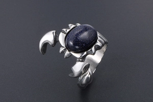 Detailed side view of vintage scorpion ring with blue sandstone in titanium steel