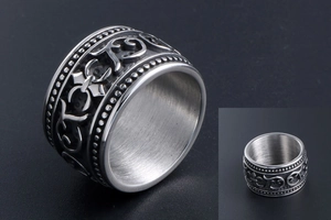 Detailed close-up of retro titanium steel ring with ornate floral vine engravings