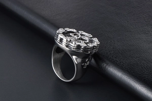 Detailed view of skull ring with chain texture and cross engraving on black leather