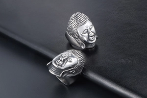 Close-up of vintage Buddha head ring in silver-tone titanium steel with detailed texture