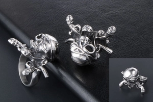 Macro shot of pirate skull ring with crossed daggers in vintage stainless steel finish
