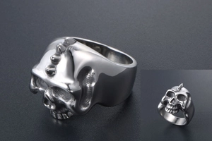 Detailed close-up of retro silver punk skull ring with gothic spike texture and aged finish