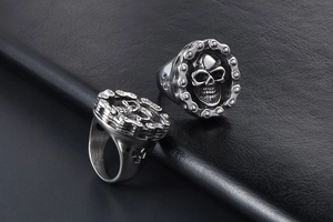 Macro detail of vintage skull ring with mechanical chain edge and cross engravings