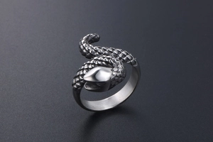 Detailed view of punk snake ring featuring engraved scales and polished silver finish