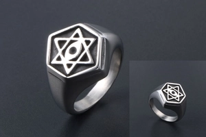 Macro view of vintage stainless steel signet ring with starburst and all-seeing eye detail