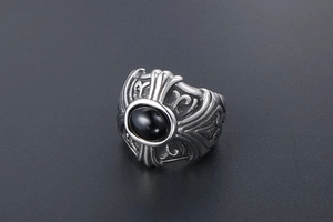 Gothic titanium steel ring with black oval stone and embossed cross relief pattern