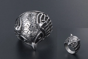 Macro shot of vintage owl ring showing detailed feather texture and silver-toned owl face