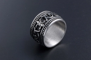 Macro detail of titanium steel wide band ring with vintage filigree and beaded edges