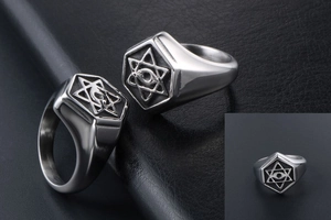 Macro detail of a vintage masonic signet ring featuring the star of david and eye design