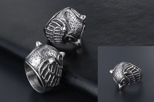 Macro shot of owl ring detail showing vintage textured feather carving and silver-black finish