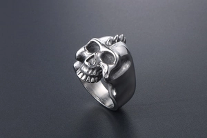 Macro shot of punk skull ring with three top spikes and vintage oxidized steel finish