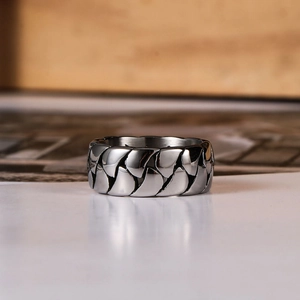 Men's titanium steel ring featuring an industrial scale texture in bright silver finish