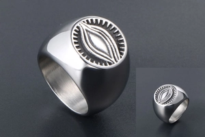 Macro shot of silver eye of providence relief engraving on vintage steel ring