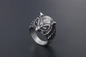 Close-up of retro owl head ring featuring detailed embossed feathers and oxidized silver finish