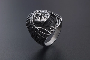 Detailed close-up of retro punk Indian chief head ring with oxidized steel feathers