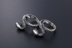 Macro detail of silver titanium snake rings showing realistic scaled texture and punk design