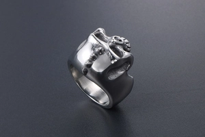 Close-up of a punk style skull ring made of vintage silver-tone stainless steel for men
