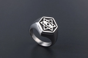 Close-up of vintage steel signet ring with engraved hexagram and eye symbol