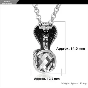 Detail of cobra pendant in stainless steel with cross motif and clear rhombic crystal