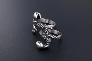 Detailed close-up of two silver punk snake rings with realistic 3D scale textures