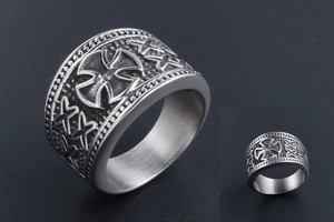 Detailed macro of vintage cross and star engravings on stainless steel band ring