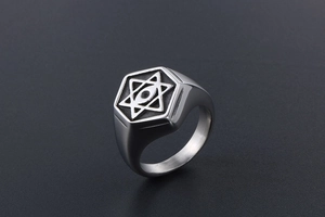Close-up of vintage steel ring with engraved star of david and all-seeing eye motifs