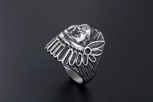 Macro detail of vintage punk Indian chief steel ring with intricate feather texture