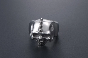 Detailed close-up of a punk skull ring with triple studs and vintage steel texture