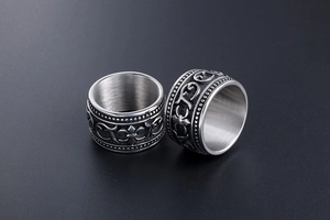 Detail of baroque engraved silver ring featuring vintage patterns and brushed inner metal