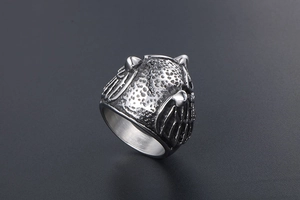 Macro view of vintage owl armor ring showing detailed silver texture and grainy relief