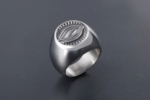 Macro detail of silver vintage signet ring with engraved All-Seeing Eye and gear motif